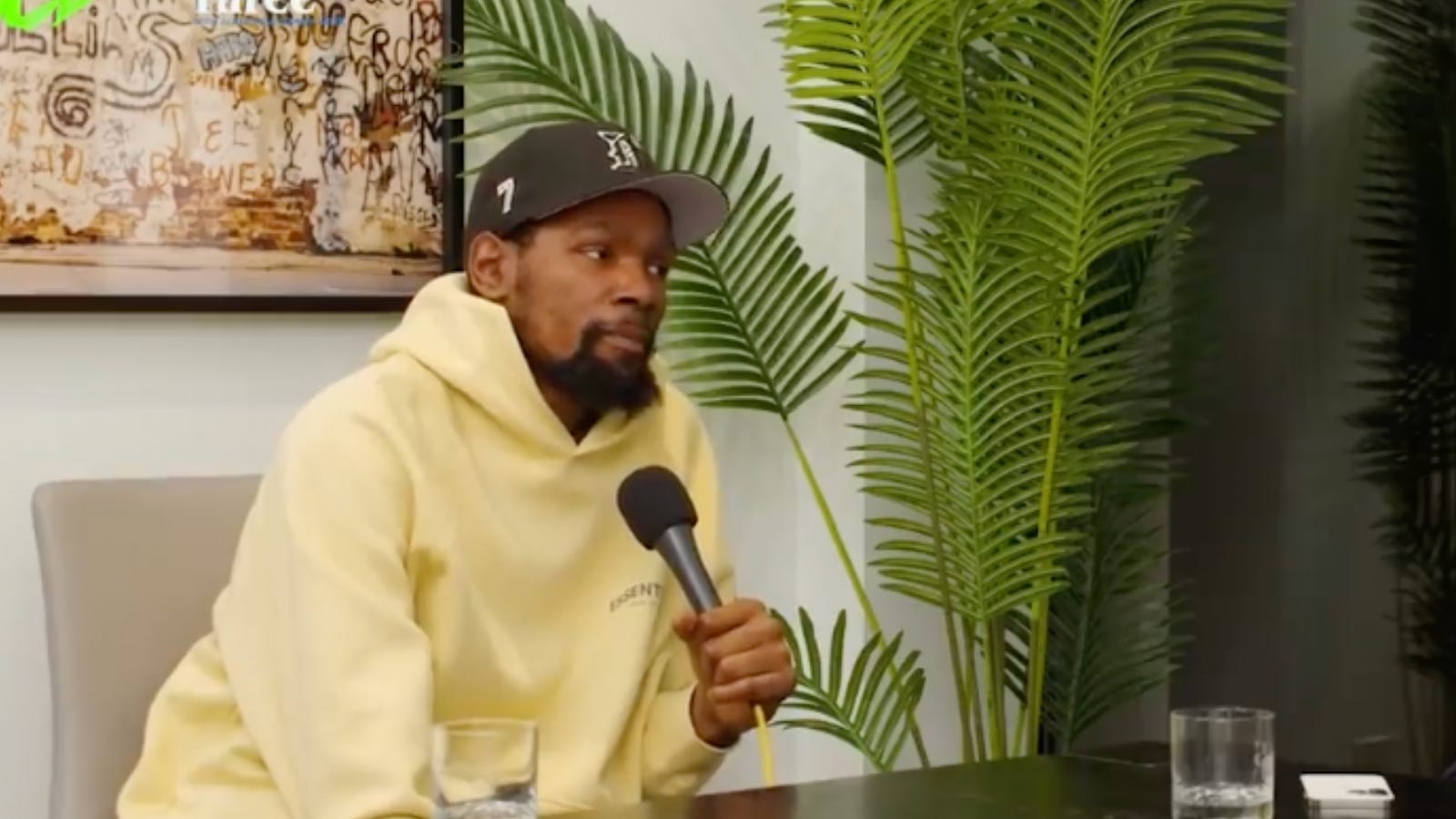 Kevin Durant speaking into a microphone during a podcast interview