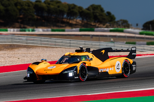 Orange McLaren race car on track